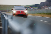 A Volkswagen ID.5 electric car drives around a test track at the company's Zwickau plant in Germany. The carmaker says making enough batteries to power the EVs needed as a result of the EU's combustion engine ban will be a challenge.