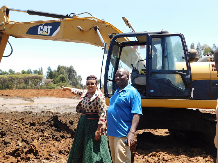 Nyandarua woman rep,Faith Gitau and Engineer George Mbugua of Elicon Construction Company at Museveni Dam in Wereu,Ol Joro Orok.The colonial dam is being rehabilitated by the national government at a cost of 19 milion