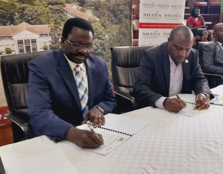 Kabarak University Vice Chancellor, Henry Kiplagat (left) and Media Council of Kenya Chief Executive Officer, David Omwoyo sign a Memorandum of Understanding to allow partnerships in media education and internship placements.