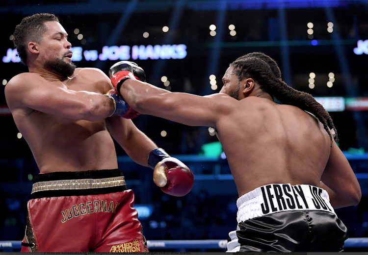 Joe Joyce blocks a punch from Joe Hanks during first round knock out win by Joyce in a past WBA Continental Heavyweight bout.