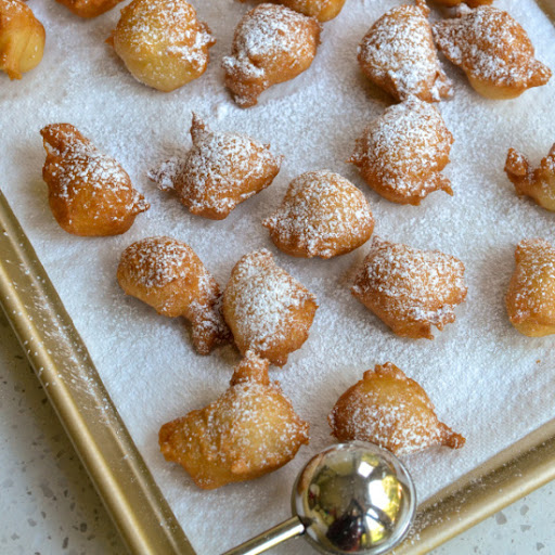 Italian Zeppole are easy to make yeast dough balls that are fried and coated in powdered sugar.