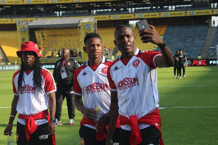 Highlands Park players do their pitch inspections.