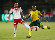 Morocco's Hakim Ziyech (L) blocks an attempted cross from Sifiso Hlanti (R) of South Africa during an Afcon match in Cairo on July 1 2019 at Al Salam Stadium. 