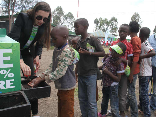 Dettol East Africa Head of Marketing Damira Golubic gives children tips on hand washing at Our lady of Nazareth Primary school at Mukuru wa Njenga slum in Nairobi county