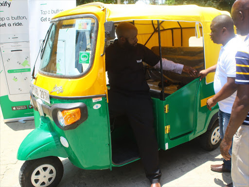 Tuk Tuk driver Maxwell Otieno welcomes Nominated Mombasa MCA Moses Aran for a ride, during Taxify Kenya's launch of a safety app for over 200 tuk tuk drivers, at City Blue Hotel in the county, May 29, 2018. /JOHN CHESOLI