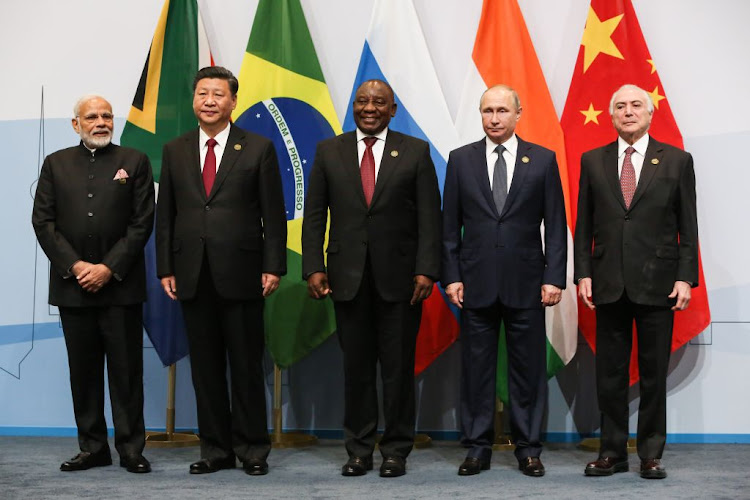 From left: Indian Prime Minister Narendra Modi, Chinese President Xi Jinping, South African President Cyril Ramaphosa, Russian President Vladimir Putin and Brazilian President Michel Temer pose for a photograph during the 10th Brics leadership summit in Sandton, Johannesburg on July 26, 2018.