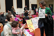 Elizabeth, speaks with another anti-vaccine mandate protester during the board meeting of Portland Public School about a proposed coronavirus disease vaccine mandate for students 12-years-old and above in Portland, Oregon, US on October 26, 2021. 
