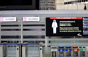 A notice about Covid-19 safety measures is pictured next to closed doors at a departure hall of Narita international airport in Narita, east of Tokyo, Japan, on November 30 2021. File Photo.