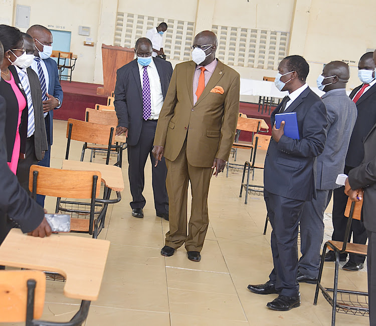 Education CS George Magoha (centre), MMUST acting VC Prof Solomon Shibairo (right) with other university and ministry officials inspect a lecture hall on Thursday