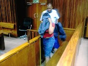 The 29-year-old woman  found guilty of  defeating the ends  of justice over the rape of her child hides her face as she leaves the courtroom in the South Gauteng High Court in  Johannesburg yesterday. / SUPPLIED
