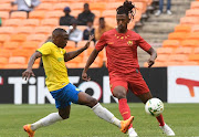 Ammar Kamaleldin Taifour of Al Merrikh challenges George Maluleka of Mamelodi Sundowns during the CAF Champions League 2021/22 match between Mamelodi Sundowns and  Al Merrikh at FNB Stadium in Johannesburg. 