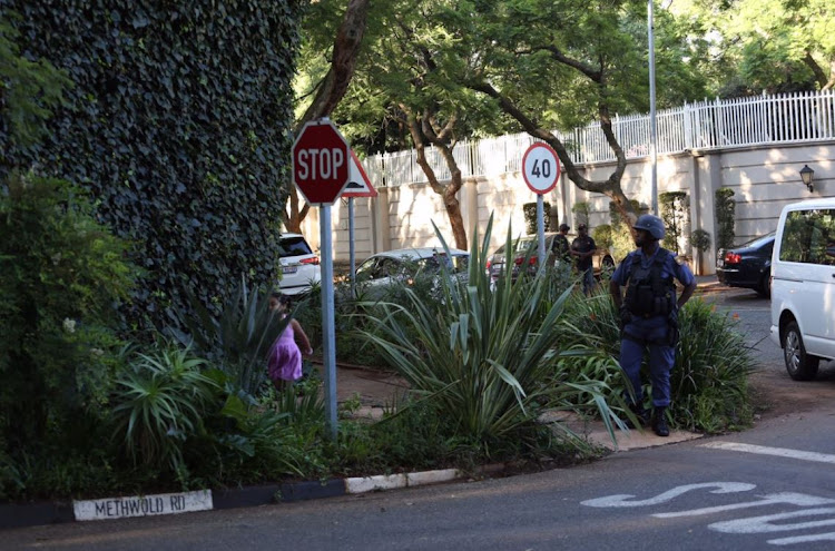 Hawks and members of the SAPS are seen outside the Gupta compound in Saxonwold, Johannesburg on 14 February 2018.