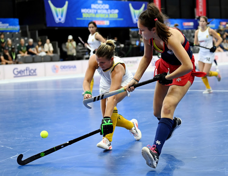 SA player Jessica Lardant battles for possession against 14-year-old Reece D'ariano of the US in their Indoor Hockey World Cup match at Heartfelt Arena in Pretoria on Tuesday morning.