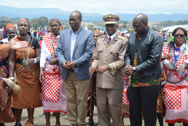 Nakuru Governor Lee Kinyanjui, county commissioner Erastus Mbui and deputy governor Eric Korir join traditional dancers to mark Mashujaa Day at Naivasha Municipal Stadium on Sunday, October 20, 2019