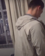 A screenshot from the video of Theuns du Toit urinating on a black student's desk and belongings.