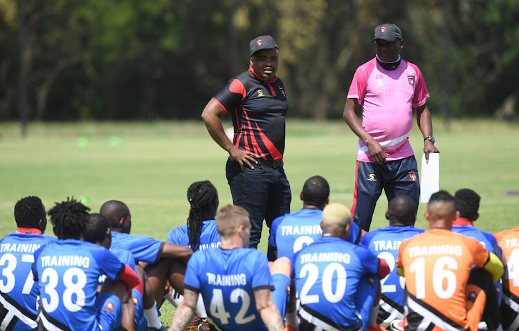 TS Galaxy owner-chairman Tim Sukazi (L) and head coach Dan Malesela (R) talk to the players during a training session at Discovery Sports Club in Johannesburg on October 22 2020.