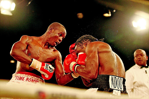 VOLATILE: Lovemore Ndou, right, absorbs some punishment from Phillip Ndou during their fight in 2009. Philip's licence has been revoked PHOTO: Simon Mathebula