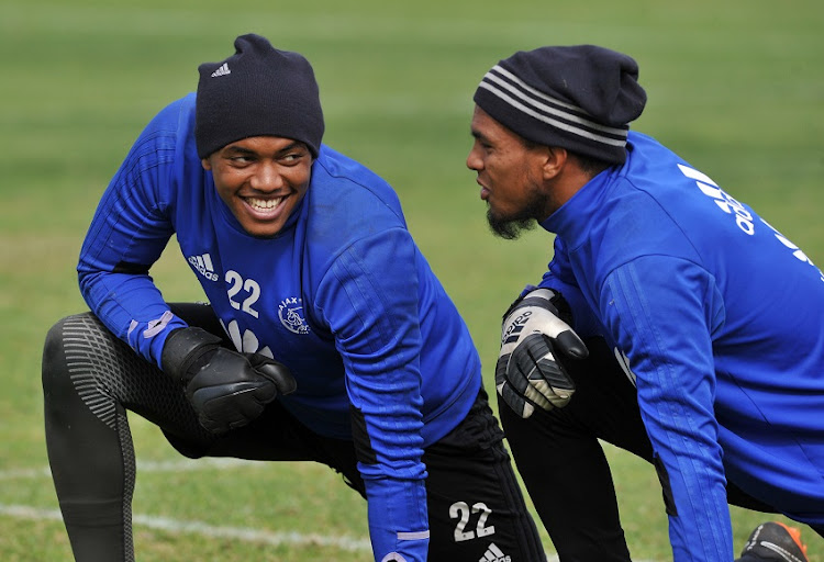 Jody February of Ajax Cape Town and teammate Brandon Petersen chat during the Absa Premiership 2017/18 Ajax Cape Town training session and press conference at Ikamva, Cape Town on 9 May 2018.