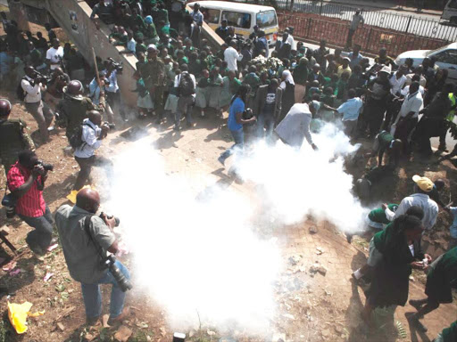 PROTEST: Pupils of Lang’ata Road Primary School react when teargas canisters were hurled at them in a demo to protest grabbing of the school's play ground. Photo/PATRICK VIDIJA