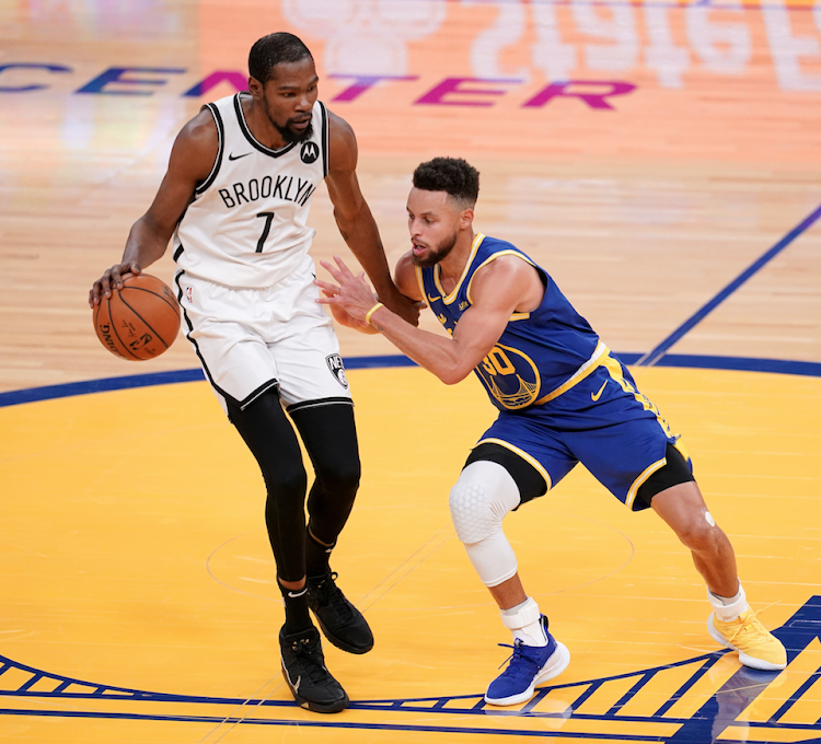 Brooklyn Nets forward Kevin Durant dribbles the ball against Golden State Warriors guard Stephen Curry (30) Cary Edmondson