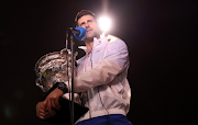 Serbia's Novak Djokovic is pictured with the trophy during an interview after winning his final match against Greece's Stefanos Tsitsipas at the 2023 Australian Open at Melbourne Park on January 29 2023.