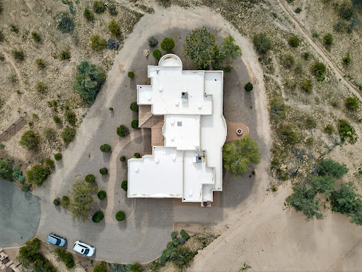 Aerial view white house flat roof garden in this luxury house for sale in Casa Grande ($690,000)
