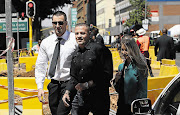 RINGSIDE SEATS: Hard man Mikey Schultz, centre, and businessman Jared Mortimer outside the Pretoria High Court yesterday, where they watched the sentencing of Oscar Pistorius from the front row of the public gallery