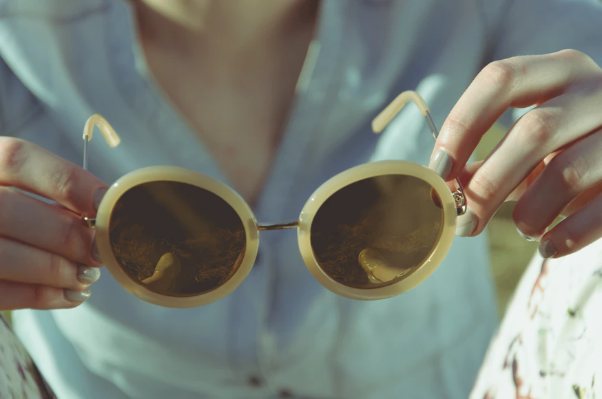 A lady handling a retro sunglass