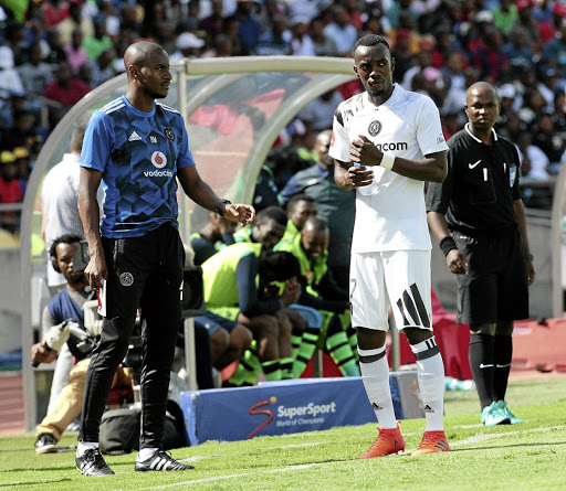 Pirates assistant coach Rhulani Mokwena prepares to brief Justin Shonga during a league match.