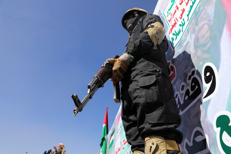 A Houthi fighter stands guard. Houthis have been targeting commercial vessels with drones and missiles in the Red Sea since mid-November. Picture: KHALED ABDULLAH/REUTERS