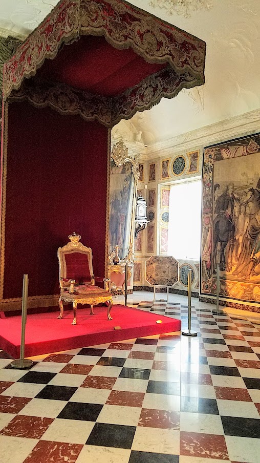 Visiting Rosenborg Castle in Copenhagen. On the third floor and is where you'll find the impressive Throne Room, also known as the Long Hall or Knights’ Hall. It was intended as a ballroom, and here you will find the coronation thrones for the king and queen and three life-size silver lions standing guard. On the other side of the room is displayed the throne for audience.