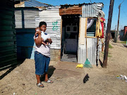 “When the fire broke out, I stepped out with only a small bucket of rice. Now, we have nothing to eat. I and my baby feel cold at night,” says Khungeka Notshokovu.  