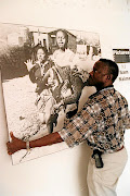 Sam Nzima with a print of his picture of Hector Pieterson being carried by Mbuyisa Makhubu after the 13-year-old was shot by police during the student uprising in Soweto on June 16 1976.