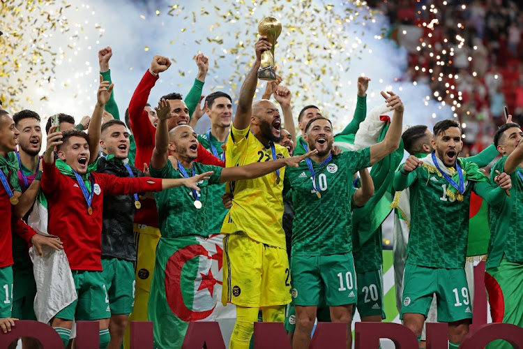 Algeria's players celebrate after winning the Fifa Arab Cup 2021 final Tunisia at the Al-Bayt Stadium in the Qatari city of Al-Khor on December 18