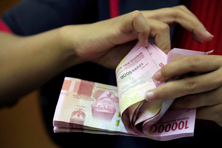 An employee counts Indonesian rupiah banknotes at a currency exchange office in Jakarta, Indonesia on October 23 2018. File Picture: REUTERS/BEAWIHARTA