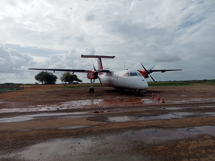 A plane lands on a flooded, muddy section of the Manda airport in Lamu which is under rehabilitation.