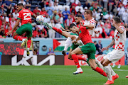 (Left to right) Youssef En Nesyri of Morocco, Mario Pasalic of Croatia and Nayef Aguerd of Morocco compete for the ball at a set piece in the World Cup Group F match at Al Bayt Stadium on November 23 2022.