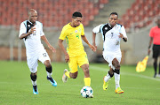 Bafana Bafana winger Neo Gift Links (C) runs away from Gilbert Baruti and Kabelo Seakanyeng during a Cosafa Cup matche between South Africa and Botswana at Peter Mokaba Stadiuml, Polokwane on June 8 2018.