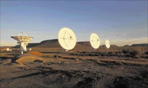 IN RANGE: Radio telescope dishes of the KAT-7 Array point skyward as the sun sets over the proposed South African site for the Square Kilometre Array (SKA) telescope near Carnavon in the Northern Cape. Photo: Reuters