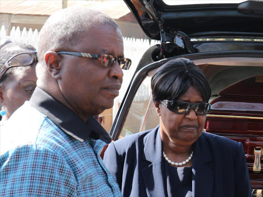 Former heritage minister William ole Ntimama’s son, Amos (left) wife Dorcas (centre ) and a relative when the remains of the former minister arrived at their Motonyi home in Narok town on September 15,2016. /KIPLANG’AT KIRUI.