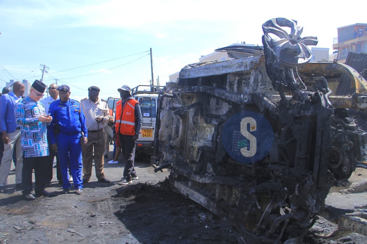 Government Spokesperson Isaac Mwaura in the company of police officers at the scene of the Embakasi fire tragedy in Nairobi on February 2, 2024