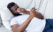 Cover your nose with a tissue or elbow when sneezing. Stock photo.