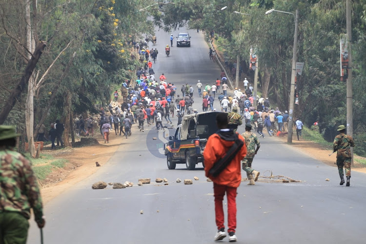Former Mungiki leader Maina Njenga's supporters running after police lobbed teargas to disperse them.