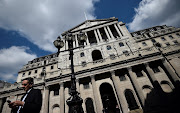  A man stands outside the Bank of England in the City of London.