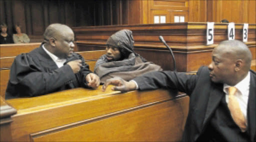 ASSAULTED? Xolile Mngeni's legal team, Advocate Qalisile Matthews Dayimani and his assistant Sithibile Elvis Tebe, with their client in the High Court. PHOTO: ESA ALEXANDER