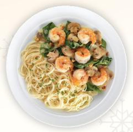 Shrimp sauteed with fresh spinach, mushrooms, and pine nuts - topped with a lemon-butter sauce, and served with capellini pasta.