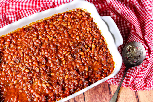 A dish filled with Southern Sausage Baked Beans.