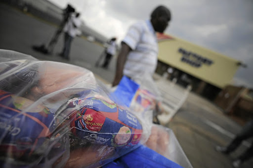 In this file photo, a business owner is seen returning a bulk of his food including polony and russians to the store following listeriosis outbreak.