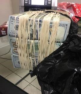 Bundles of dollars found in the hand luggage of a student who boarded a flight to Hong Kong