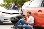 Two motorists are frantic on their phones after a crash. 